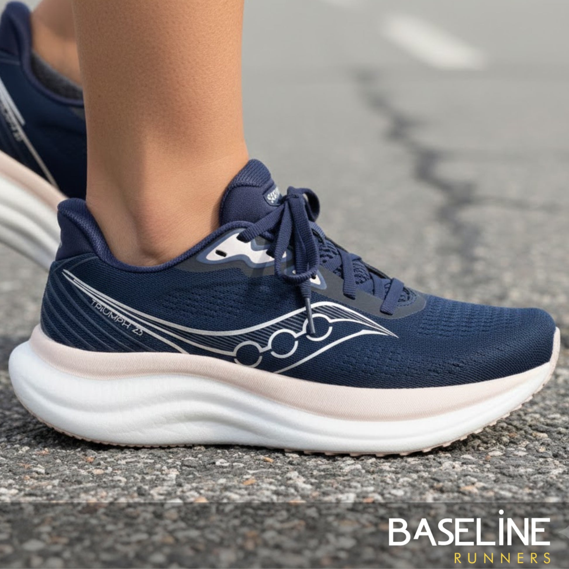 Navy running shoe with white sole on a road, featuring the 'Baseline Runners' brand.