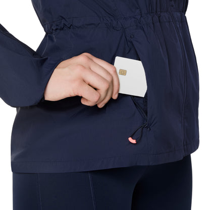 Person wearing a navy blue jacket holding a white card with a gold emblem.