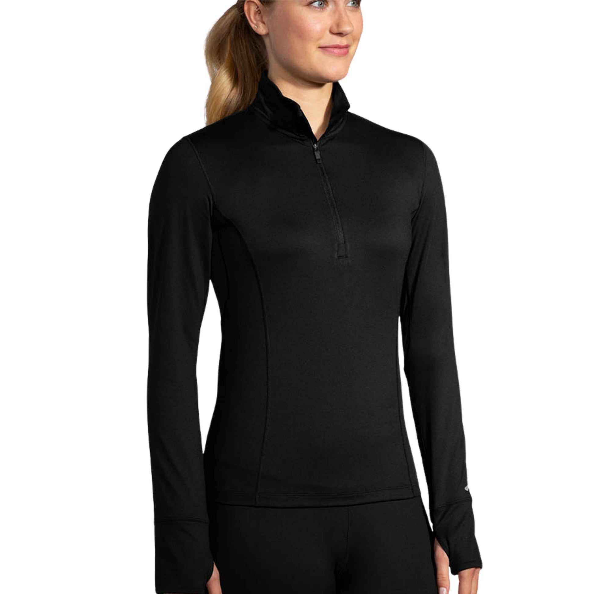 Woman wearing a black long sleeve Brooks shirt on a white background