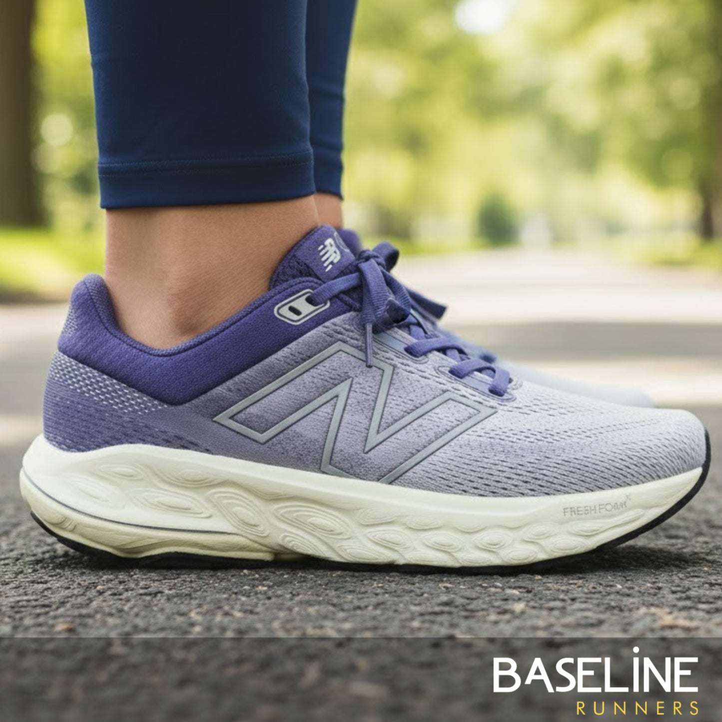 Purple running shoe with white sole on a blurred outdoor background