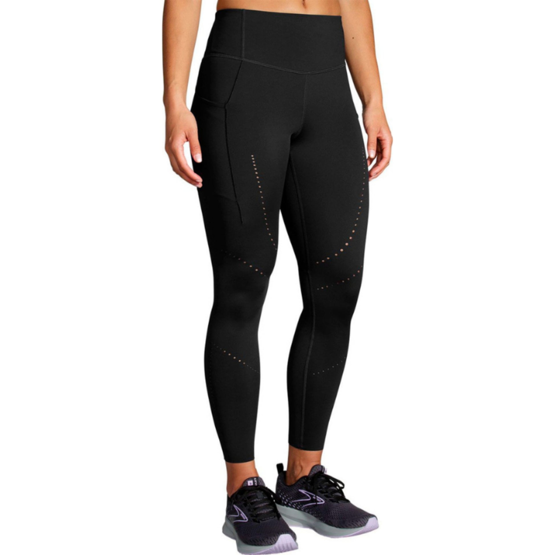 Woman wearing a black Brooks legings on a white background