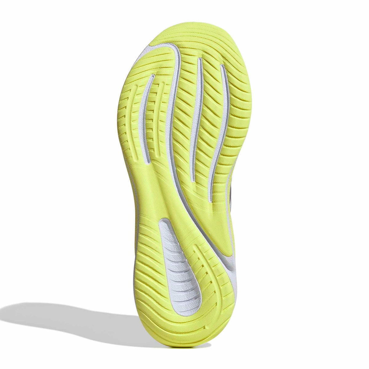 A single running shoe shown from the sole view, featuring a bright neon yellow-green outsole with white textured accents and grooved tread patterns, set against a plain white background with a soft shadow.