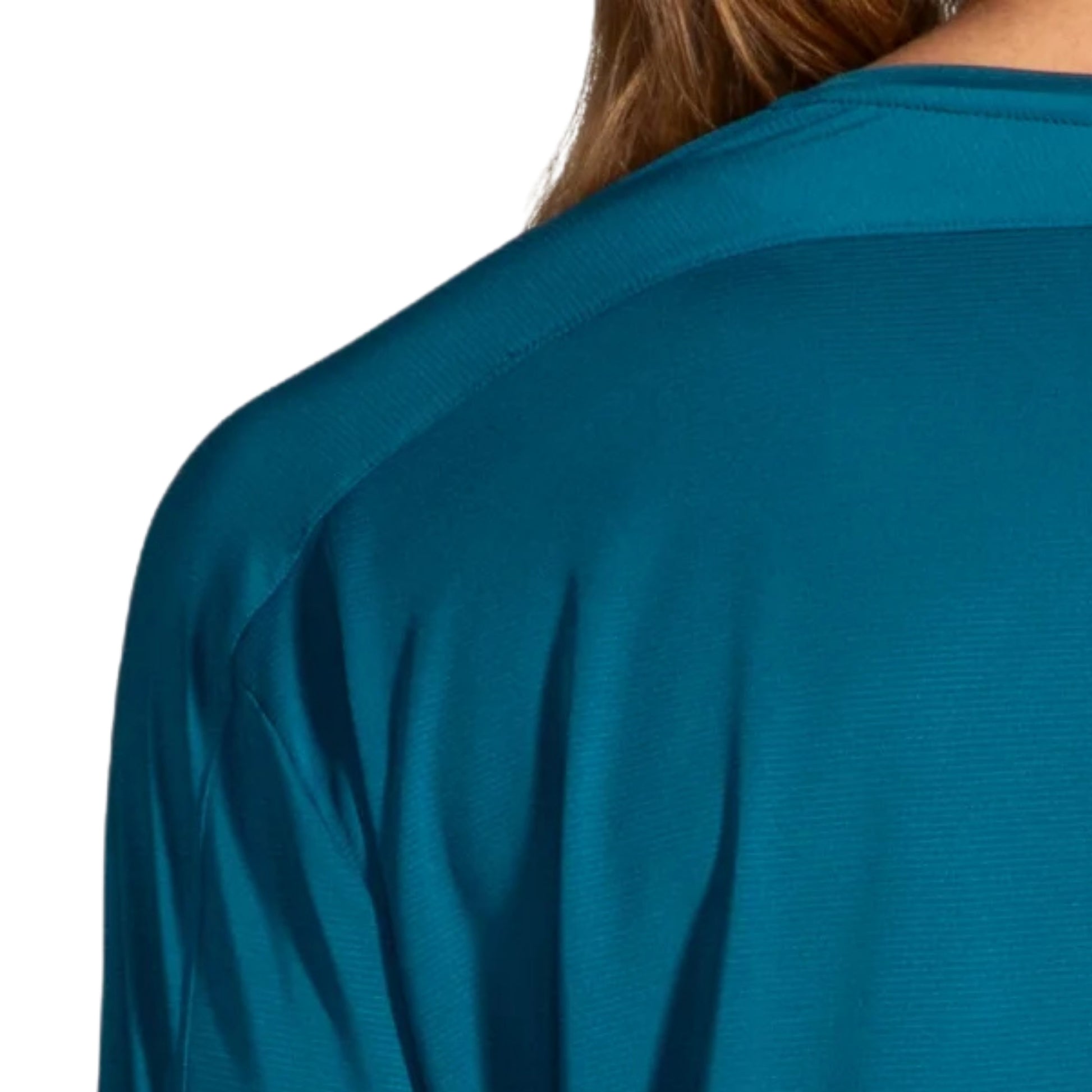 Woman wearing a blue Brooks shirt on a white background