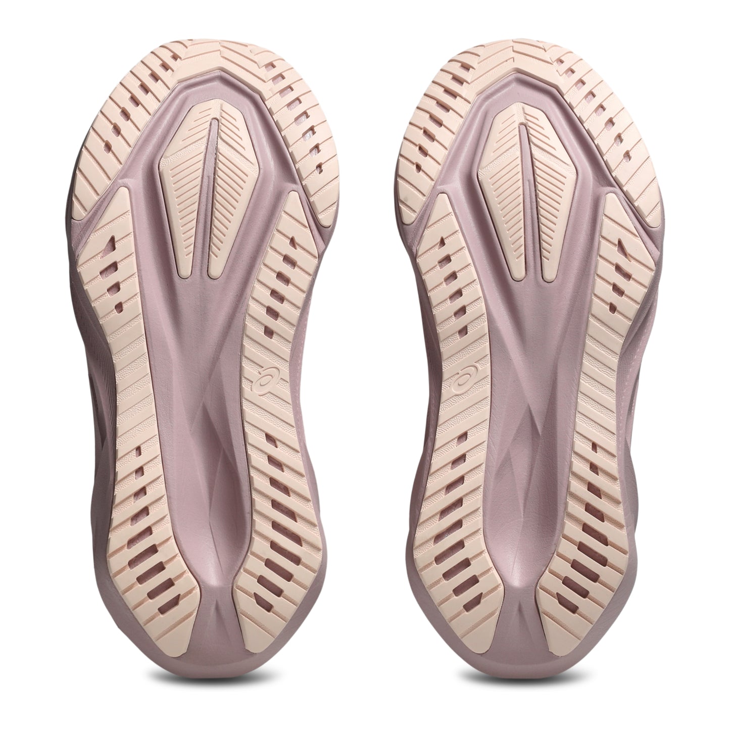 Close-up of a pair of shoe soles with a textured design on a white background
