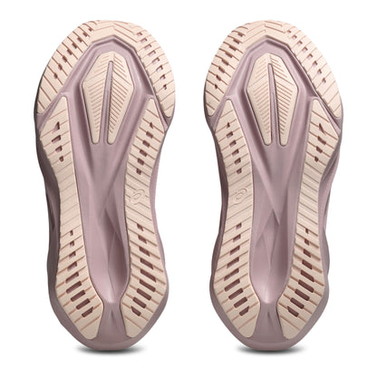 Close-up of a pair of shoe soles with a textured design on a white background