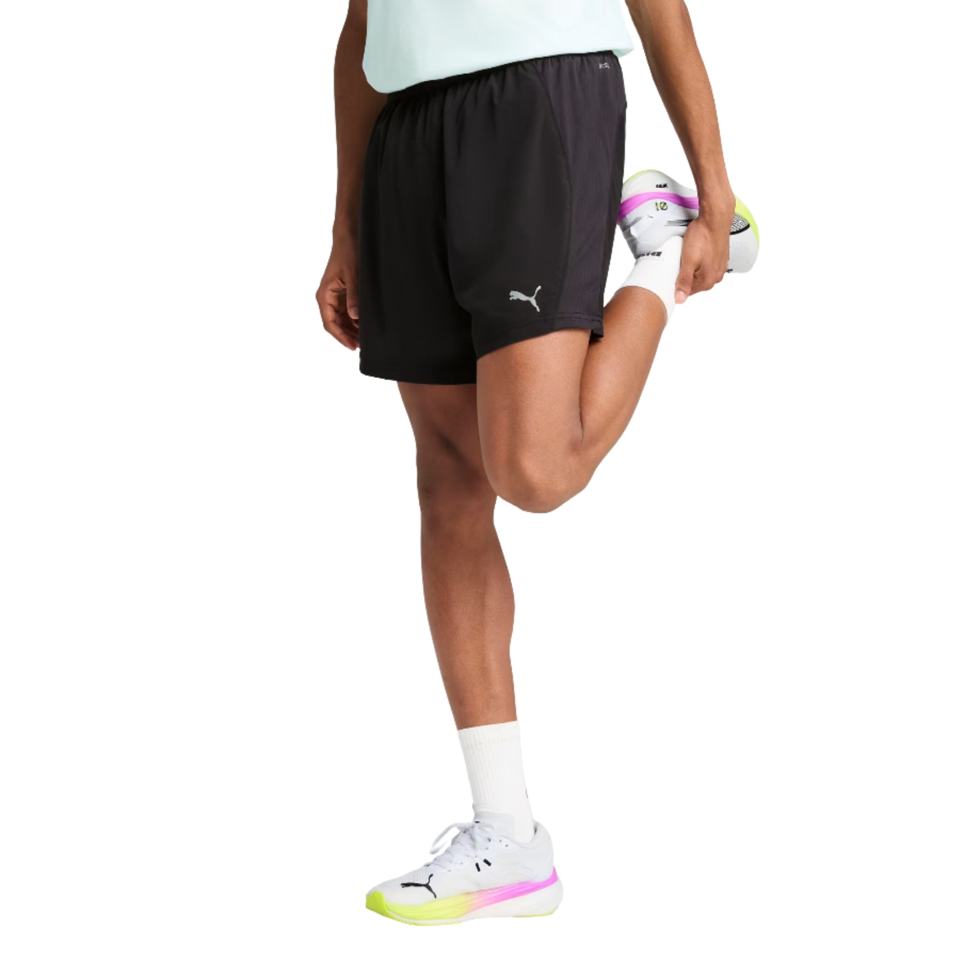 Person wearing black Puma shorts with a visible brand logo on a white background