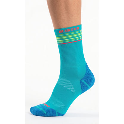 A single crew sock shown on a cropped human foot and lower leg against a clean white studio background. The sock is predominantly bright turquoise/teal with darker blue heel and toe areas, thin multicolor horizontal stripes near the cuff, and pink text reading 'BLUSTER' on the cuff.
