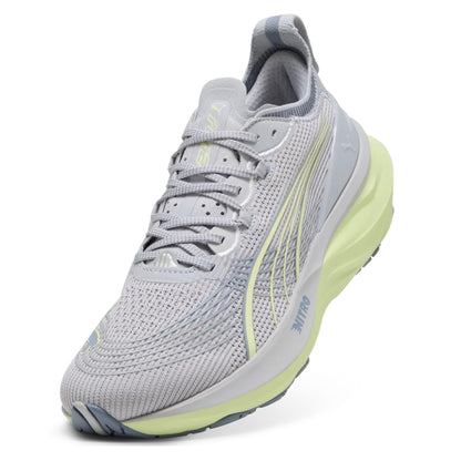 Gray Puma running shoe with green sole on a white background