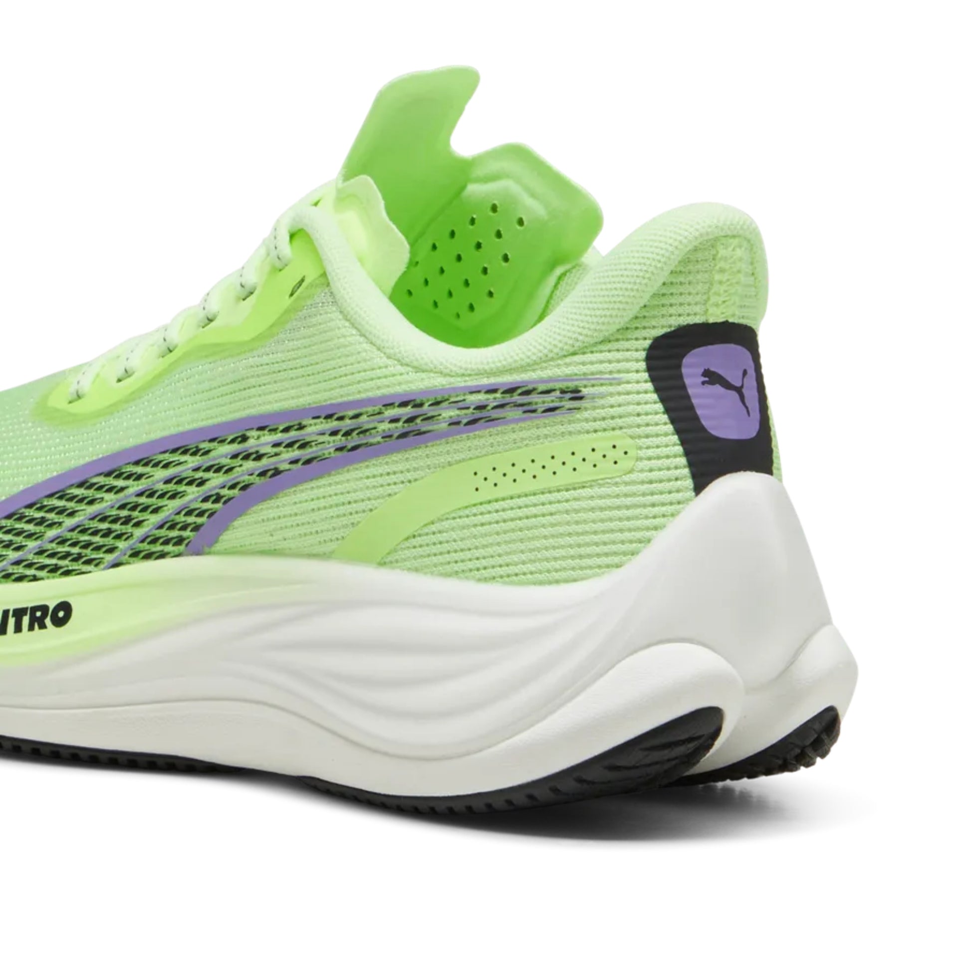 Neon green Puma running shoe with white sole on a white background