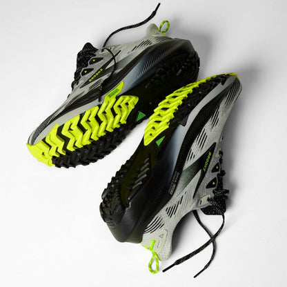A pair of Brooks running shoes in gray, black, and neon yellow-green, shown from a top-down angle on a light gray background.