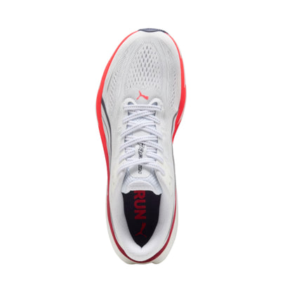 A Puma running shoe shown from a top-down view, featuring a white mesh upper with red and dark gray accents, white laces, and a black heel insert with red 'RUN' text.