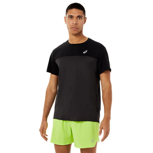 Man wearing a black and grey Asics shirt with the Asics logo on the left side on a white background