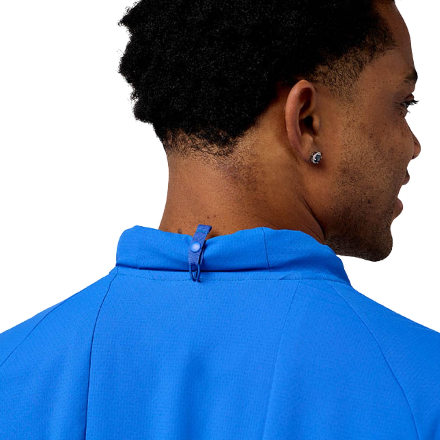 Close-up of a man wearing a blue Brooks jersey on a white background