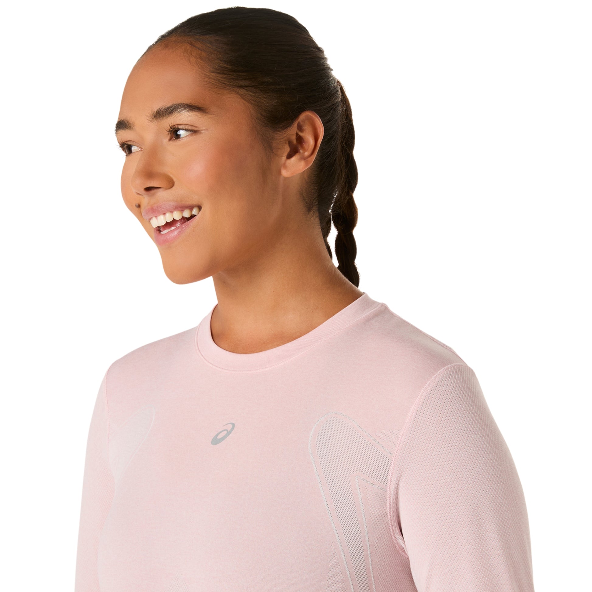 Woman wearing a light pink long-sleeve athletic shirt with a brand logo on a white background