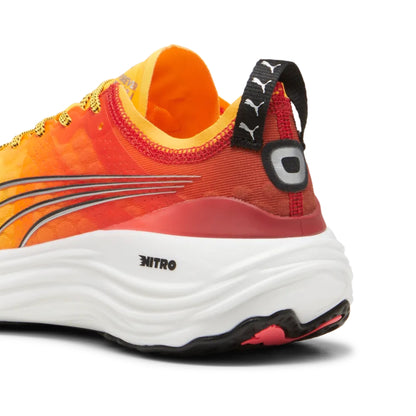 Yellow and orange Puma running shoe with white sole on a white background