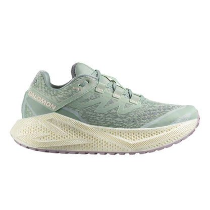 Light green Salomon running shoe with a white sole on a white background