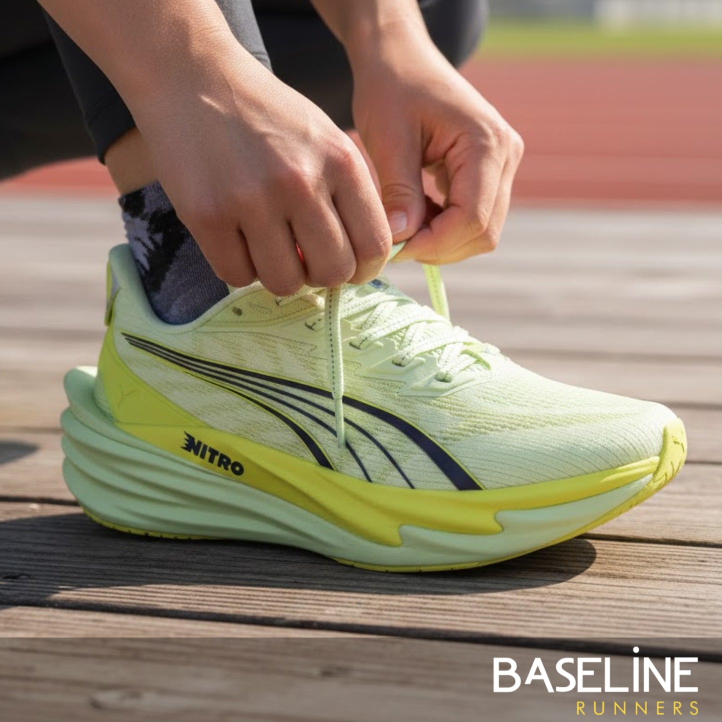 Person tying a yellow Puma running shoe on a track, with 'Baseline Runners' branding.
