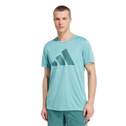 A man wearing an Adidas mint shirt