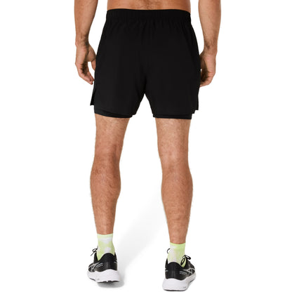 Person wearing black athletic shorts on a white background