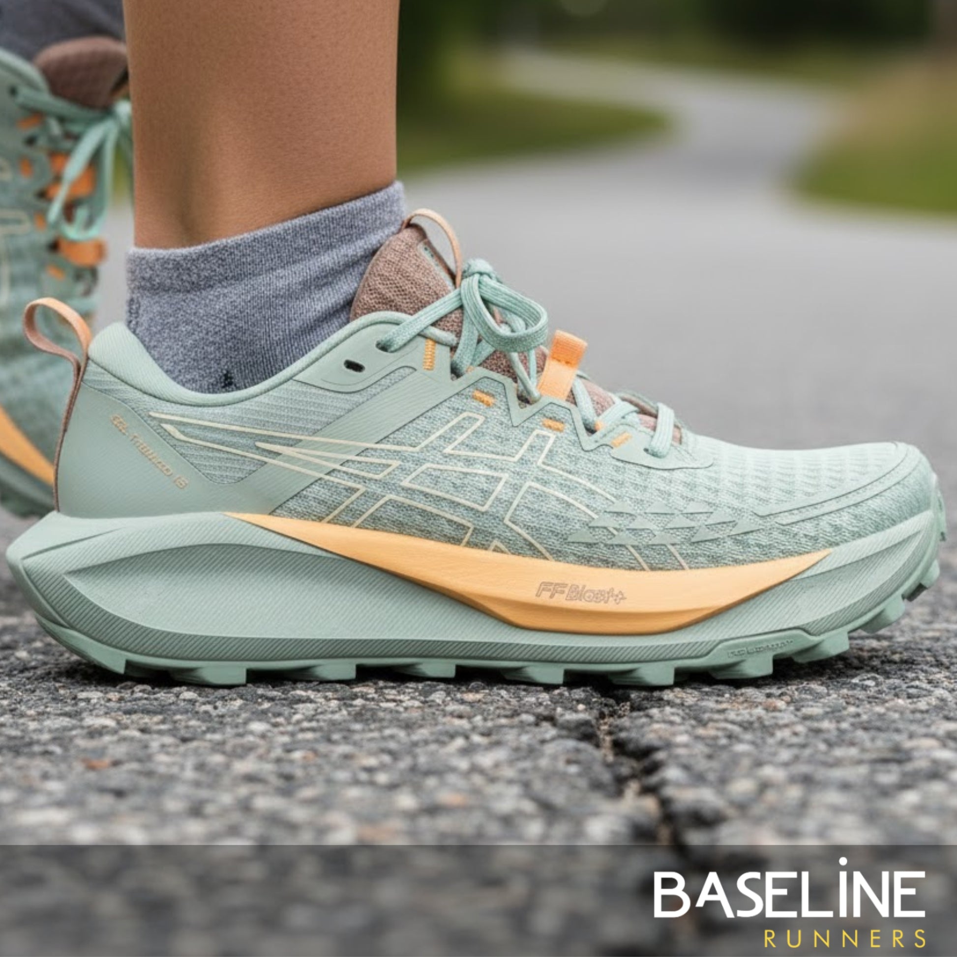 Asics running shoe with green and warm yellow tan accents and FF Blast+ on the outside 