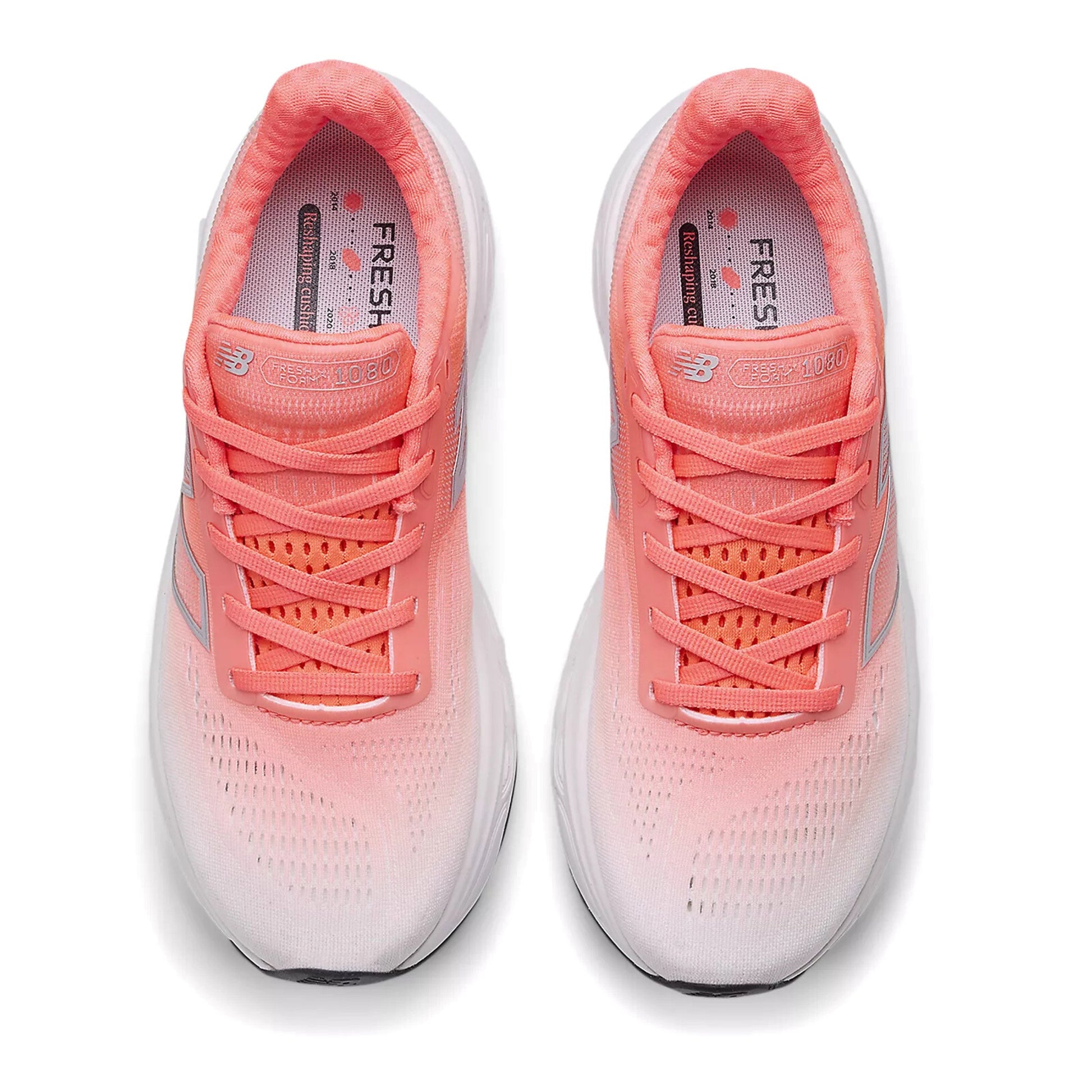 Pair of red and white running shoes with white soles on a white background