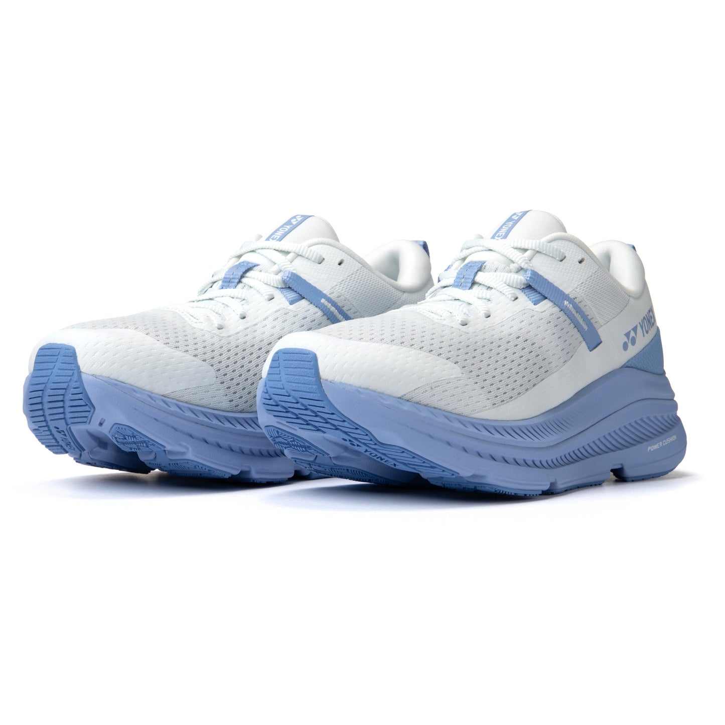 White and blue Yonex running shoes on a white background