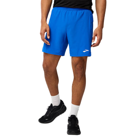 Person wearing blue running shorts with a brand logo on a white background