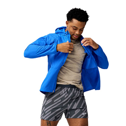 Man wearing a blue Brooks jersey on a white background