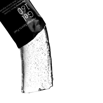 A close-up of a black sachet labeled 'Gel 160' and 'Hydrogen Sports Fuel' with a clear gel substance dripping from the bottom against a white background.