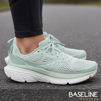 Light green running shoes on a road with 'Baseline Runners' branding.