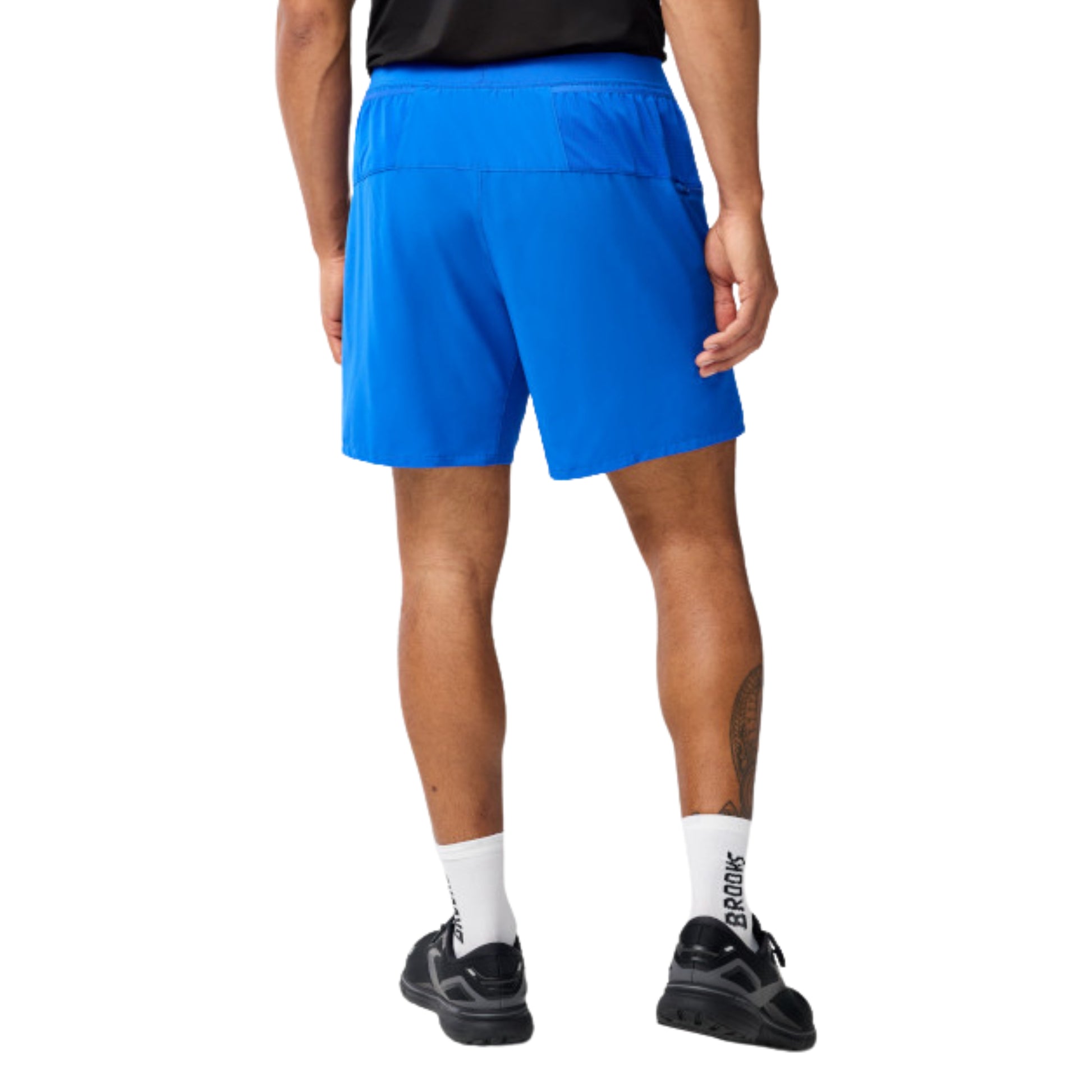 Person wearing blue running shorts on a white background
