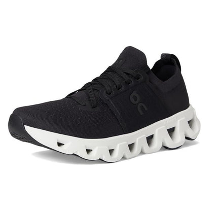 A black On running shoe with a distinctive wavy white sole, shown from a three-quarters angle on a white background.