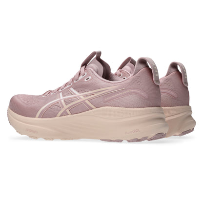 Pair of pink running shoes with a white sole on a white background