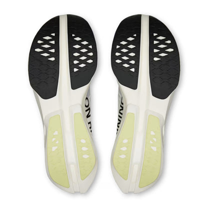 Top-down view of a pair of On running shoes soles, showing a white and black design with pale yellow-green heel pads and a textured black outsole.