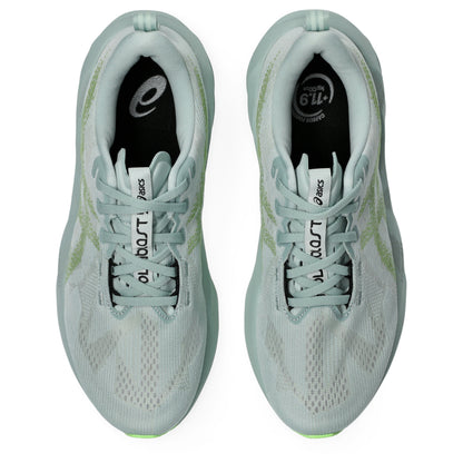 Light blue Asics running shoes with green sole on a white background