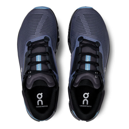 Pair of blue running shoes with black soles on a white background