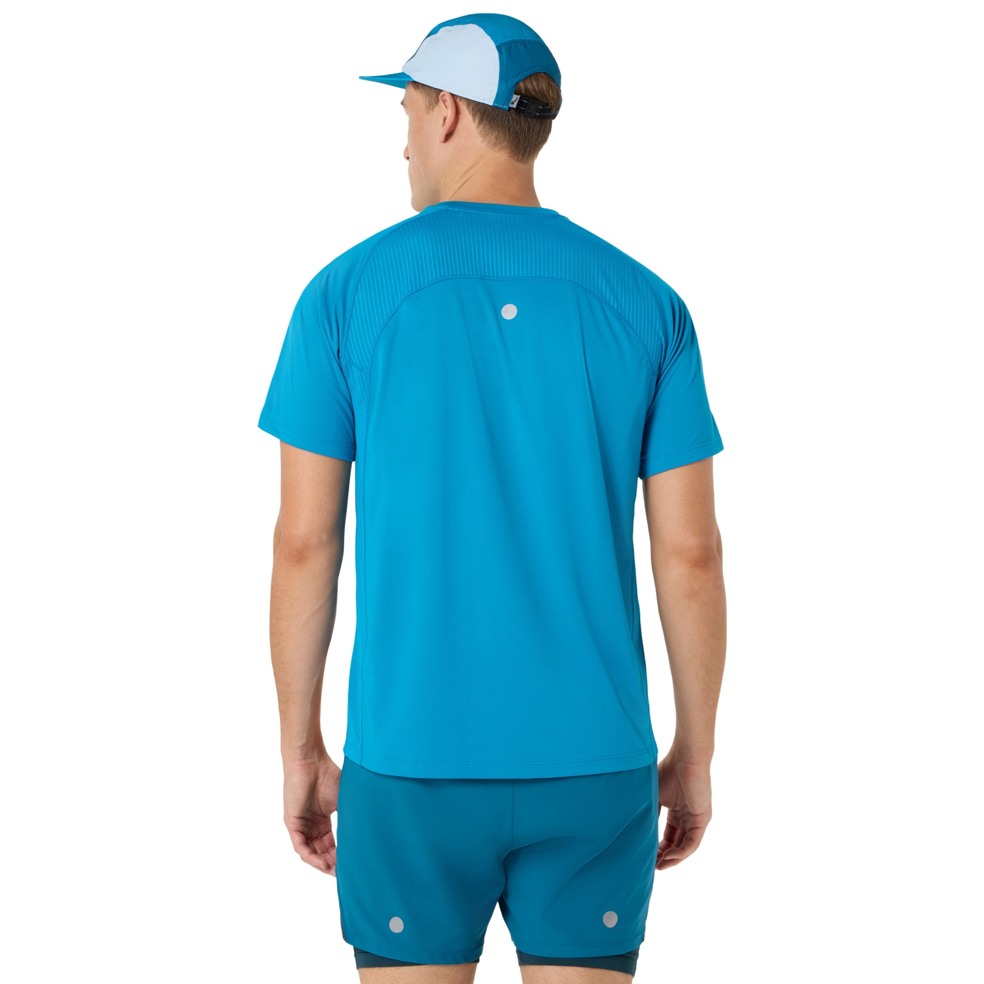 Person wearing blue and yellow Asics running shirt on a white background