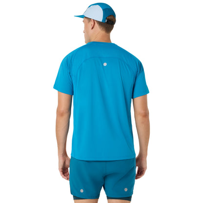 Person wearing blue and yellow Asics running shirt on a white background