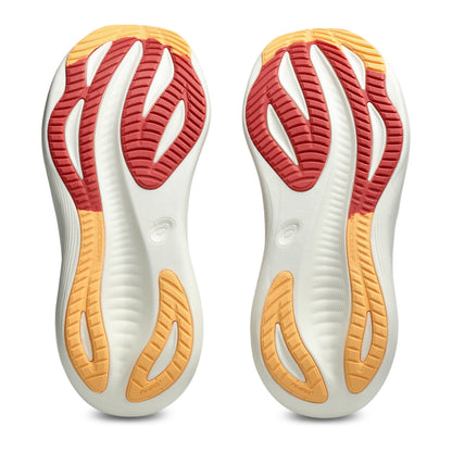 Close-up of a pair of running shoes with white, red, and orange sole design on a white background