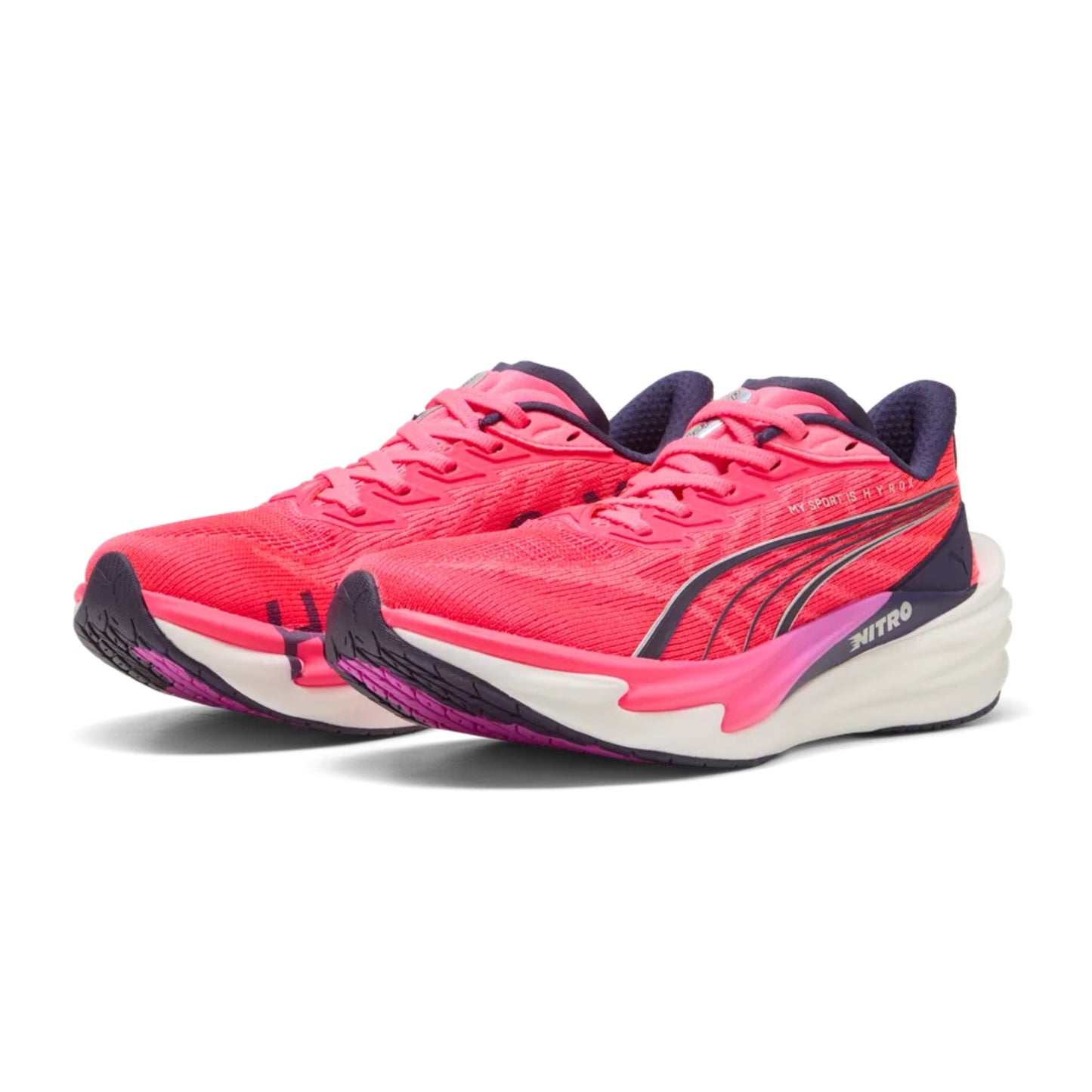 Pink Puma running shoes with white soles on a white background