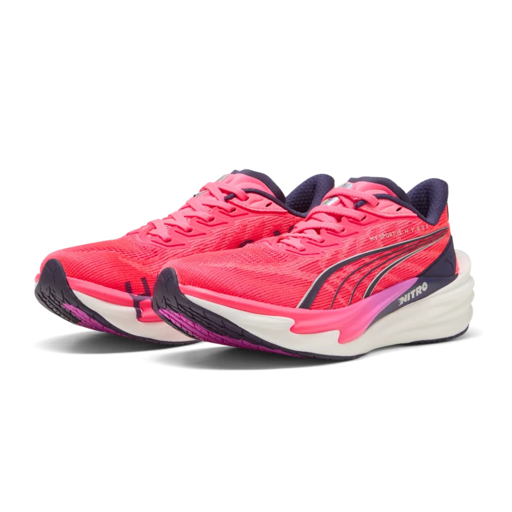Pink Puma running shoes with white soles on a white background
