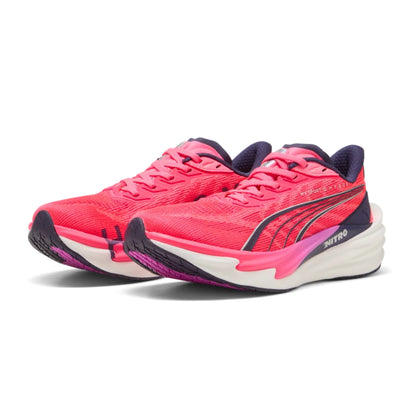 Pink Puma running shoes with white soles on a white background
