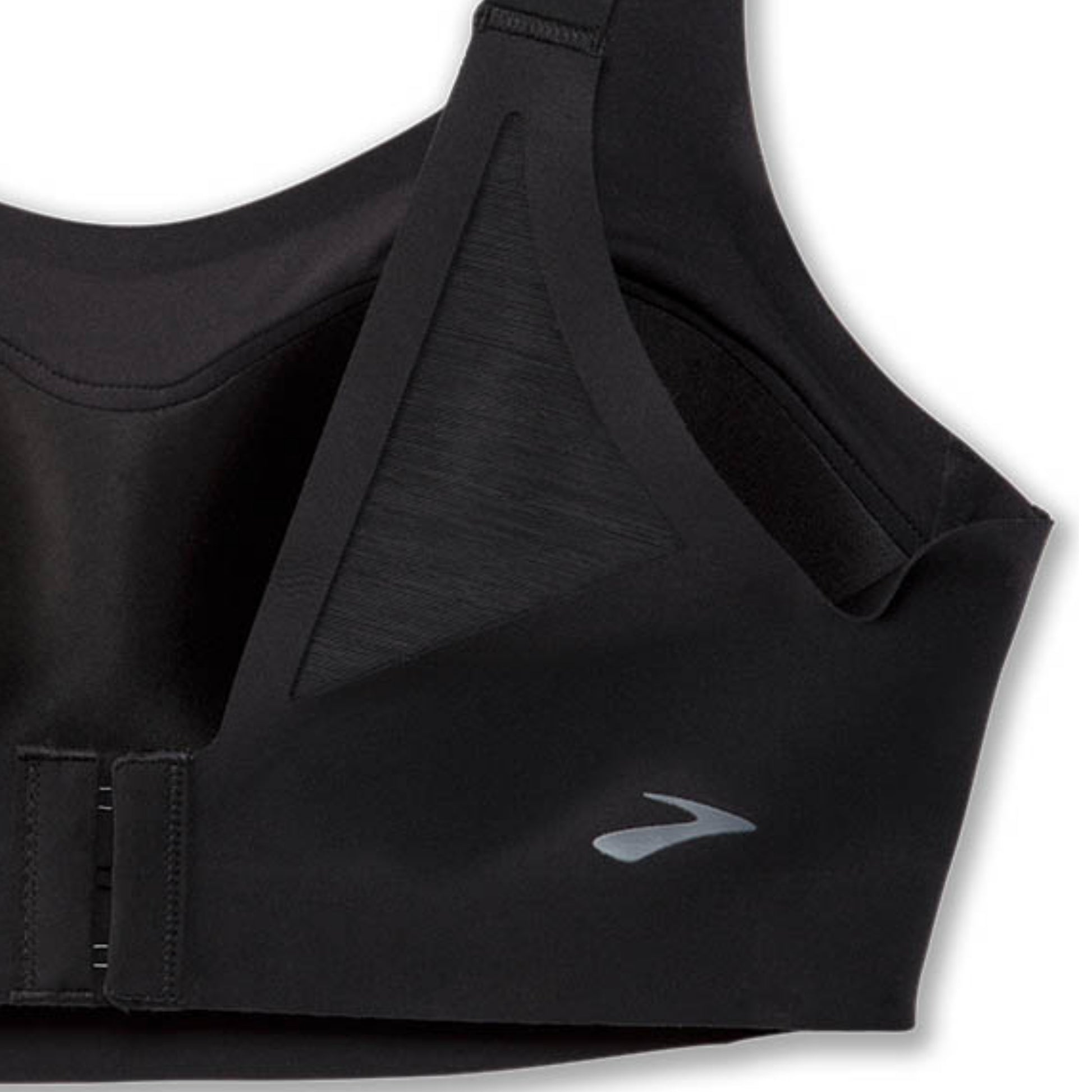 Close-up of a black sports bra showing the underband closure and a small silver logo on the side, set against a plain white background.