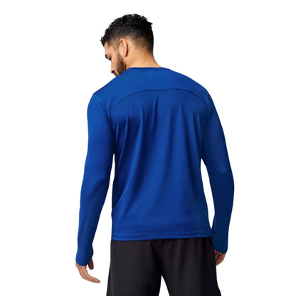 Man wearing a blue Brooks long sleeve shirt on a white background