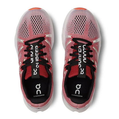 Pink running shoes with black laces and visible branding on a white background