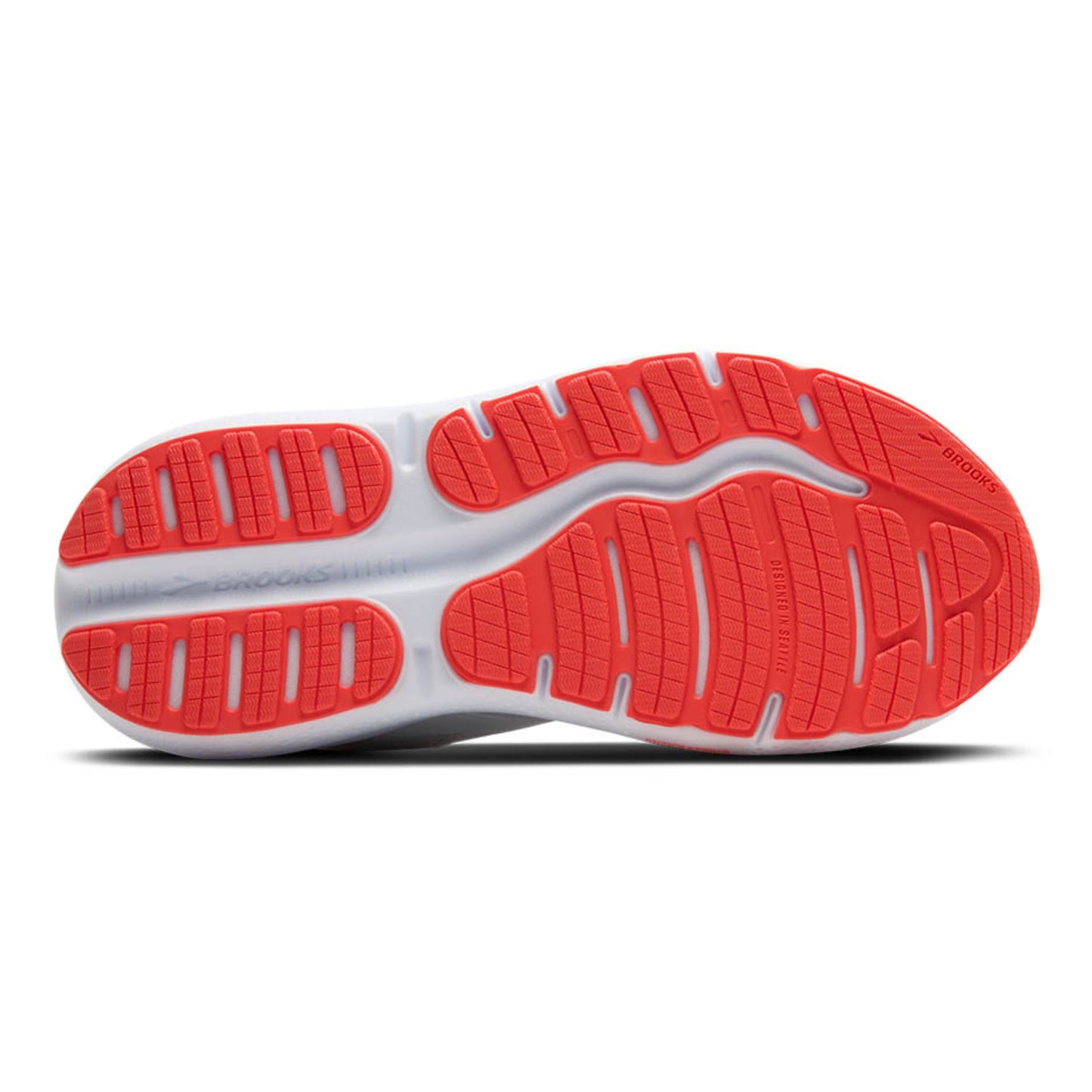 Close-up of a shoe sole with red and white tread pattern on a white background