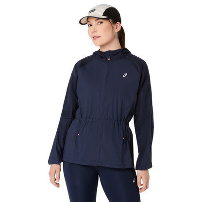Person wearing a navy asics jacket on a white background