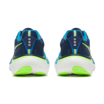 Navy and green running shoes on a white background
