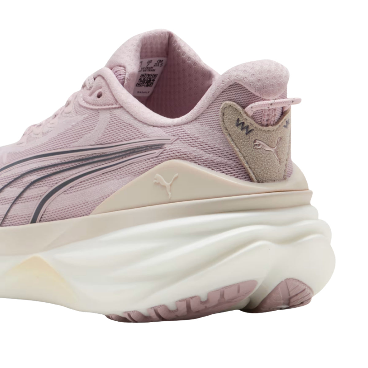 A close-up side view of a Puma running shoe in dusty pink and beige, showing the side stripes, heel tab, and thick cushioned sole on a white background.