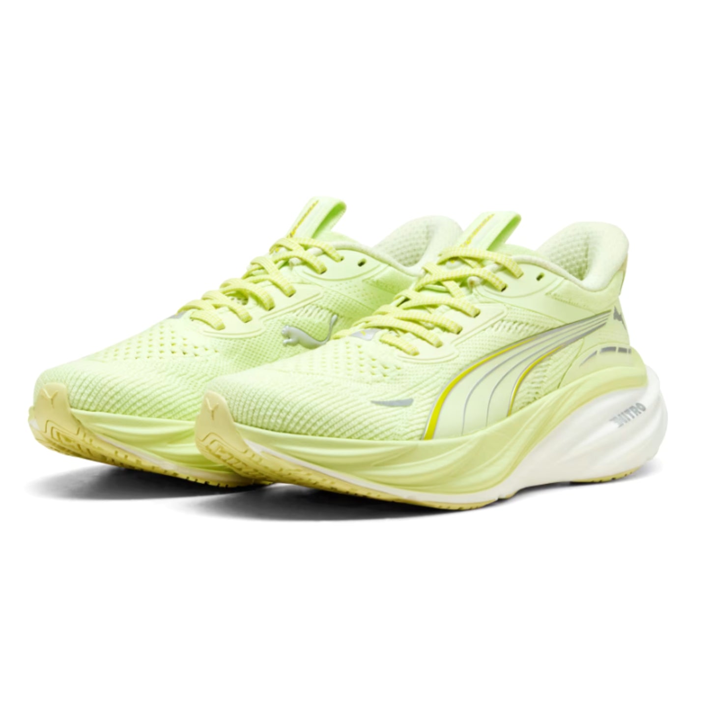 Pair of light green Puma running shoes on a white background
